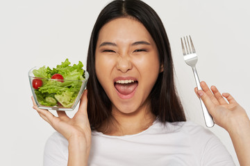 Wall Mural - young woman eating salad