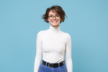Smiling Young Brunette Woman Girl In Casual White Clothes, Eyeglasses Posing Isolated On Pastel Blue Background Studio Portrait. People Emotions Lifestyle Concept. Mock Up Copy Space. Looking Camera.