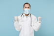 © ViDi Studio - Happy male doctor man in white medical gown sterile face mask gloves isolated on blue background. Epidemic pandemic coronavirus 2019-ncov sars covid-19 flu virus concept. Doing winner gesture say yes.