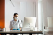 © Yakobchuk Olena - Caucasian doctor in medical mask and rubber gloves working at laptop