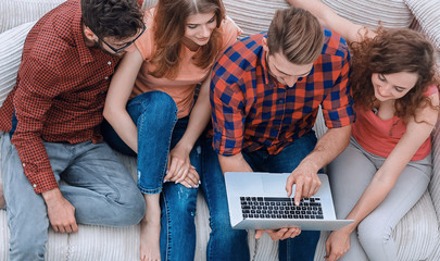 Poster - group of friends with a laptop,discussing the video