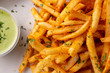 © DAVID - A closeup view of a tray of cajun style french fries in a restaurant or kitchen setting.