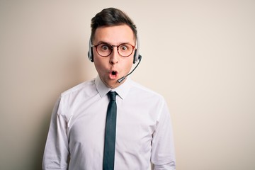 Sticker - Young handsome caucasian business man wearing call center headset at customer service afraid and shocked with surprise expression, fear and excited face.