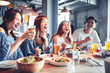 © Tom Wang - happy young group dining and drinking beer at restaurant