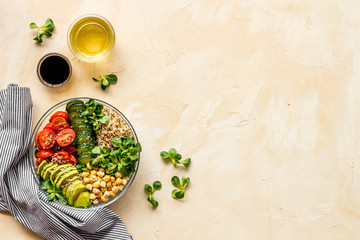 Wall Mural - Vegan bowl. Avocado, quinoa, tomato, spinach and chickpeas vegetables salad on beige table top-down copy space