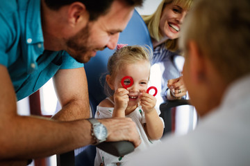 Wall Mural - Ophthalmologist, optometrist checking child vision looking for problems and caring for eye