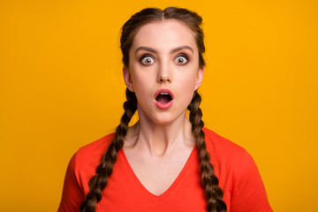 Closeup photo of attractive shocked lady two long braids open mouth listen unexpected awful news eyes full fear wear casual red t-shirt isolated vibrant yellow color background