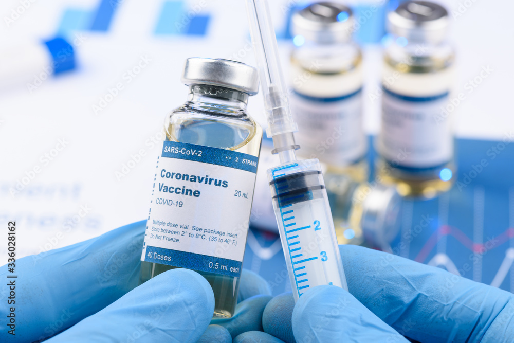 Coronavirus COVID-19 vaccine vial and injection syringe in scientist hands concept. Research for new novel corona virus immunization drug. - obrazy, fototapety, plakaty 
