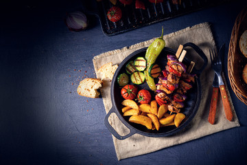 Wall Mural - Shish kebab with various vegetables and spice country potatoes