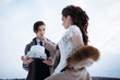© Alexey Tsibin - the bride treats the groom to a wedding cake. Wedding photography in winter in nature