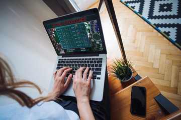 Cropped shot of female hands using laptop typing on keyboard