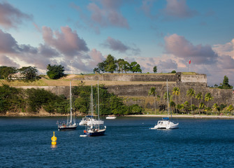 Canvas Print - Sailboats in bay off Martinique by old French Fort