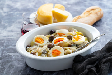 Wall Mural - typical portuguese dish codfish with potato and egg on white dish