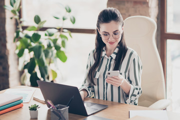Close-up portrait of nice attractive smart clever cheery focused girl secretary assistant using device creating new plan meeting at modern brick loft industrial interior style workplace workstation