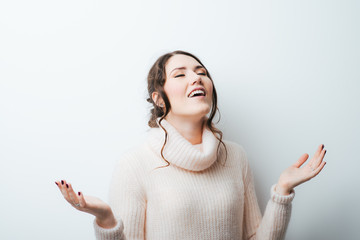 brunette girl praying and looking at the sky on a white background