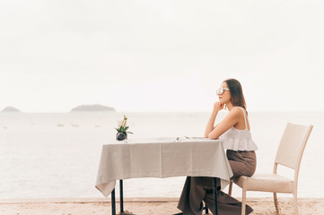 Girl enjoying tropical view on summer vacation.Women waiting for someone.