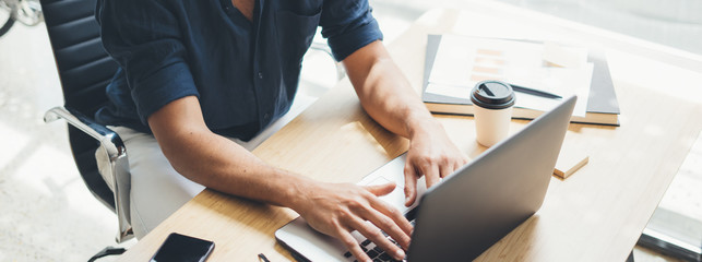 Man working on laptop at bright studio