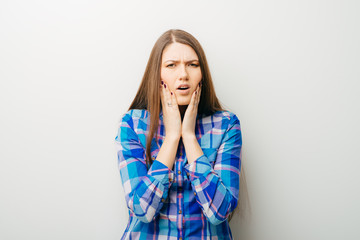 Wall Mural - on a white background a young girl toothache