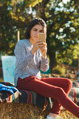 Poster - woman making photo with mobile phone in sunlight