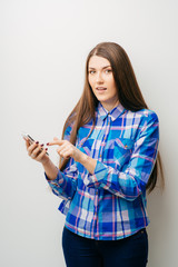 Wall Mural - young woman typing on mobile phone on white background