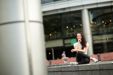 Wall Mural - happy young woman sitting down relaxing