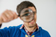 © aeroking - on a gray background young man with a magnifying glass