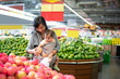 © Odua Images - mother shopping in grocery store while carrying her baby