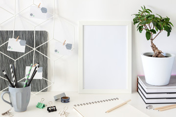 Wall Mural - Creative desk at home against a white wall background. Mockup frame.