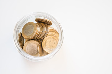 Bimetallic 1 Turkish New lira (TRY) coins in a jar isolated on white background