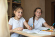 © DariaTrofimova - Teenage girls learning lessons at home.