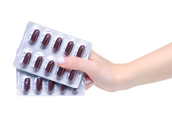 Wall Mural - blister brown pills capsules in hand medicine pharmacy on white background isolation