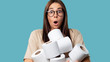 © South House Studio - Cute woman holds bunch of rolls with toilet paper, she opened her mouth in a surprise