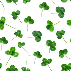 Wall Mural - Green clover, the symbol of the holiday St. patrick's day. Seamless pattern of clover leaves isolated on white background, top view, flat lay.