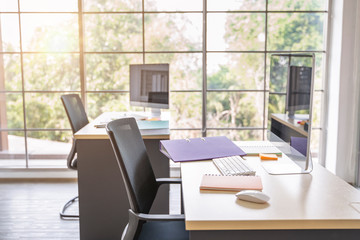 modern office set work space area with desks, chairs documents, computer, books, shelves and plant interiors, big window space for lights. Brick walls and wooden floor working environment set concept