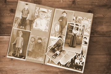 old retro album with vintage monochrome photographs in sepia color, the concept of genealogy, the memory of ancestors, family ties, childhood memories