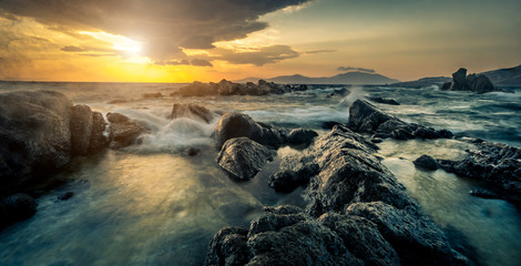 Beautiful seascape with rocks and waves at sunset