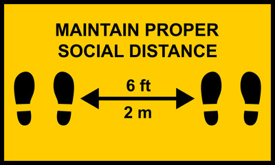 Warning sign reminding people to keep a minimum distance of six feet or two meters between them.  Social distance public health measures to prevent further spread of Covid-19 infections.