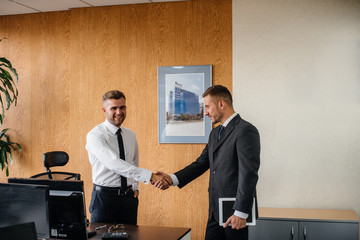 Handshake of partners, completion of the transaction in the office. Business