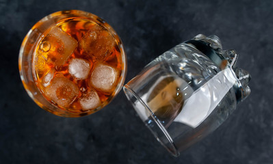 Two glasses with whiskey on a stone background .Close-up.