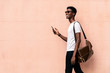 © Santi Nunez/Stocksy - African man using mobile phone