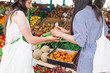 © VeaVea/Stocksy - Female friends shopping vegetables on a market