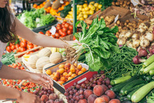 Unrecognizable Female Friends Shopping Vegetables On A Market
