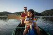 © Boris Jovanovic/Stocksy - Dad and son canoeing at the lake