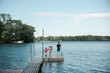 © LÈa Jones/Stocksy - teen boy fishing with little girls