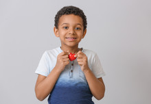 Little African-American Boy With Red Heart On Grey Background. Concept Of Donations