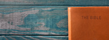 A Background With A Bible On A Rustic Wooden Table
