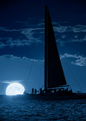 Wall Mural - this beautiful photo illustration shows a large, blue moon rise off the coast of key west florida. a