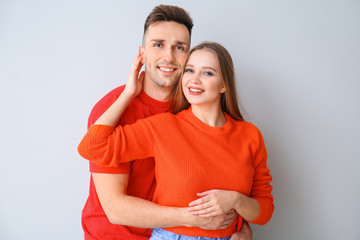 Canvas Print - Happy young couple on light background