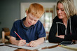 © Gabriel (Gabi) Bucataru/Stocksy - Mom Helping With Homework