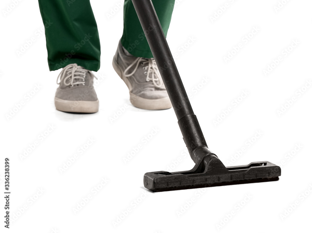 Young man with vacuum cleaner on white background
